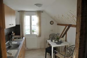 a kitchen with a sink and a table at Traumfängerhaus Engel in Prerow