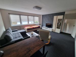 a living room with a couch and a table at Ferienwohnung/Apartment Siegen in Siegen