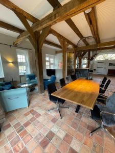 a large room with a wooden table and chairs at Ferienhaus am Wasserschloss Haus Marck in Tecklenburg