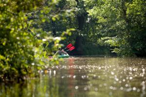 a man is in a kayak on a river at Ferienhaus 4 Prs in Kaupen
