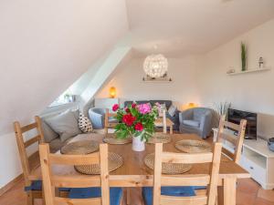 a dining room and living room with a table and chairs at Kapitänshaus Kittler - Sehnsucht - FeWo 1OG - DG in Wiek auf Rügen 