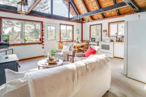 a living room with a couch and a table at Serene Lakes Cabin with Deck Dog Friendly! in Soda Springs +17 photos