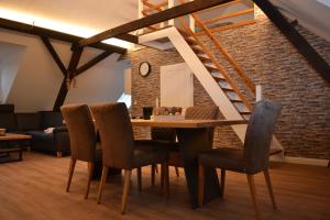 a dining room with a table and chairs and a brick wall at Ferienhof Thele Wohnung OG in Werlte