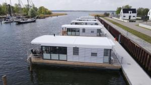 a row of boats docked at a marina at Hausboot Krosse Krabbe - LP6 in Peenemünde