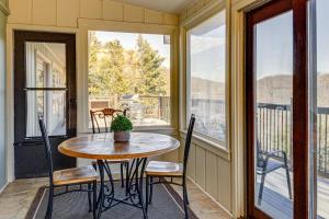a porch with a table and chairs on a balcony at Spacious Mountain-View Home 13 Mi to GSMNP! in Gatlinburg