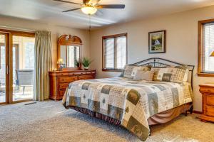 a bedroom with a bed and a ceiling fan at Spacious Mountain-View Home 13 Mi to GSMNP! in Gatlinburg +33 photos