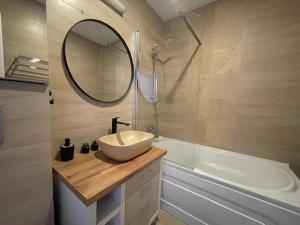 a bathroom with a sink and a mirror and a tub at Sedi Royal Cosmopolis in Ştefăneştii de Sus +20 photos