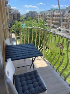 a balcony with a bench and a view of a city at Sedi Royal Cosmopolis in Ştefăneştii de Sus