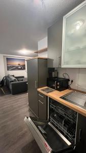 a kitchen with an open dishwasher in a room at City Unterkunft 4 in Heilbronn