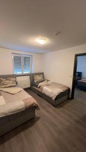 a bedroom with two beds and a mirror at City Unterkunft 4 in Heilbronn
