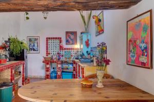 a kitchen with a wooden table in a room at Casa Sulahue in Real de Catorce