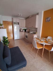 a kitchen with a table and a kitchen with a table and chairs at Dreams of San Pedro in San Pedro del Pinatar