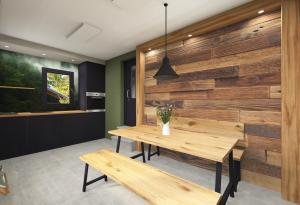 a dining room with a wooden wall at Camper Lodge CL1 in Hindenberg
