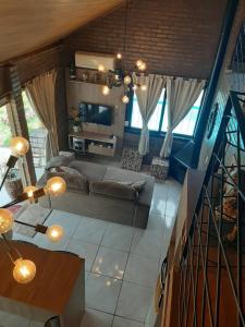 a living room with a couch and a table at Canto do Beija-flor Rolante RS in Rolante
