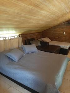 a bed room with two beds and a couch at Canto do Beija-flor Rolante RS in Rolante +50 photos