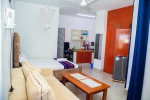 a living room with a couch and a bed at Urban Nest in Bamburi