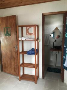 a room with a bunk bed and a door with a mirror at Casa Jasmim in Imbituba +6 photos