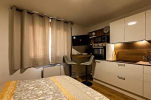 a small kitchen with a bed in a room at Le Sublime-100m de la plage-Cozy-Refait à Neuf ! in Canet-en-Roussillon