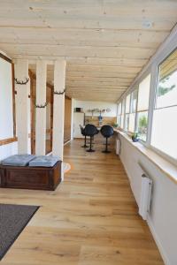 a room with wooden ceilings and a wooden floor at Ferienwohnung Steinberg mit Sauna in Rothenkirchen +9 photos
