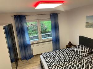 a bedroom with a bed and a window at Fewo Linde in Olpe