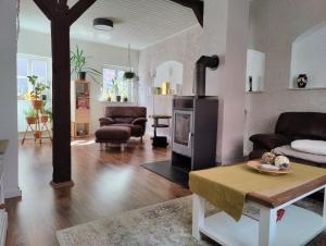 a living room with a couch and a table at Ferienhaus "Kleinod" in Boizenburg