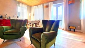 a living room with chairs and a dining room at Pierina Art Lodge in Malcesine