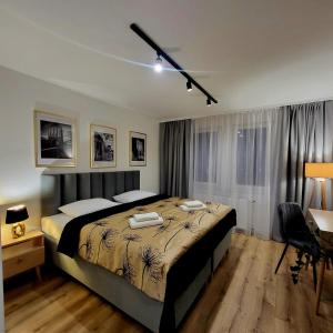 una camera da letto con un letto grande e una scrivania di Hotel Piast a Myślibórz Altre 208 foto