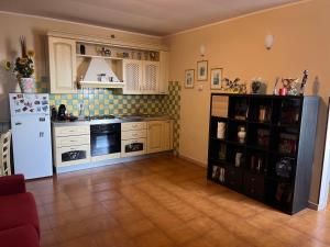 a kitchen with a white refrigerator and a tile floor at casa PaMelia in Frosinone