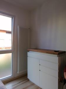 a kitchen with a white counter and a window at Appartement Vista Lago in Riva del Garda +16 photos