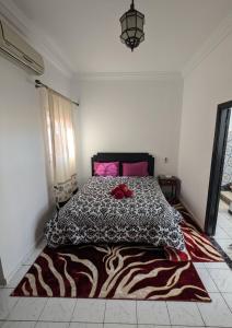 une chambre avec un lit avec une couette noire et blanche dans l'établissement Almohafidon room, à Marrakech