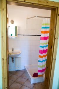 a bathroom with a bath tub and a sink at Bellevue mitte in Schashagen +6 photos