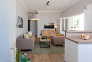 a living room with a couch and a table at Villa Seeblick Schloonsee in Ahlbeck