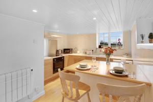 a kitchen with a table and two chairs in it at Hill House Hideaway - North East Escapes in Bardon Mill
