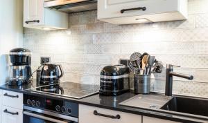 a kitchen with a sink and a counter top at Terrassen-Fewo "Ankerplatz" direkt am Ostseestrand inkl Schwimmbad in Kronsgaard