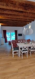 a dining room with a white table and chairs at Birkennest in Bingerbrück