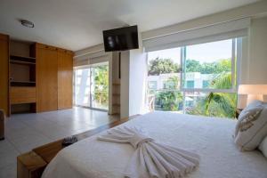 a bedroom with a large bed with a large window at Villa en Nuevo Vallarta 15 in Nuevo Vallarta 