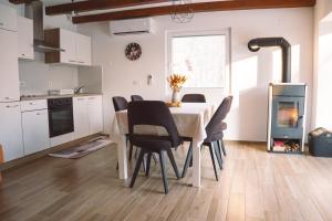 a kitchen with a table and chairs and a fireplace at Zelena harmonija in Moravske Toplice