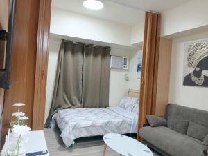 a small room with a bed and a couch at Avida Tower Riala Tower4 in Cebu City