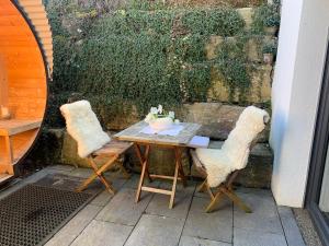 a table with two chairs and a bowl on it at Wohnung Repp in Überlingen