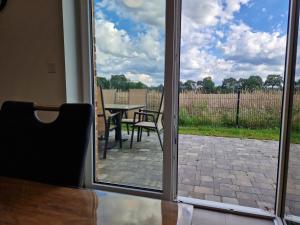 an open door to a patio with a table and chairs at Haus Hase in Haselünne