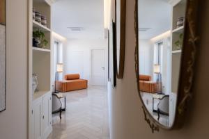 a hallway with a mirror and a living room at Abalto Suites & Rooms in Lecce