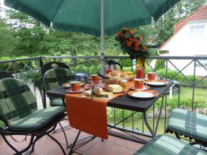 a table with food on it on a patio at FeWo Abendsonne in Prerow