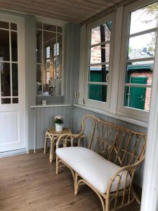 a porch with a bench and two windows at FeWo "Prerow" in Prerow