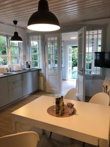 a kitchen and dining room with a table and chairs at FeWo "Prerow" in Prerow +7 photos