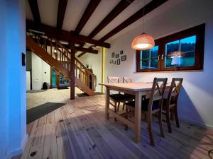 a dining room with a wooden table and chairs at Blockhaus Ourtal in Winterspelt
