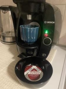 a black coffee maker with a container on a counter at Apartman Cañas Modrá Víla in Rimavská Sobota