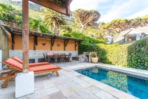 a patio with a bench and a swimming pool at St James Pool Cottage in St James