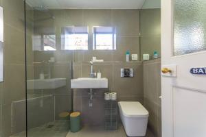 a bathroom with a shower and a sink and a toilet at St James Pool Cottage in St James +14 photos