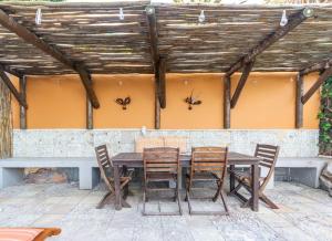 a table and chairs on a patio with spiders on the wall at St James Pool Cottage in St. James