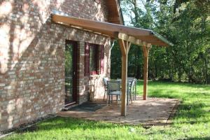 a patio with a table and chairs on a brick building at Ferienhaus Luv in Pellworm +16 photos